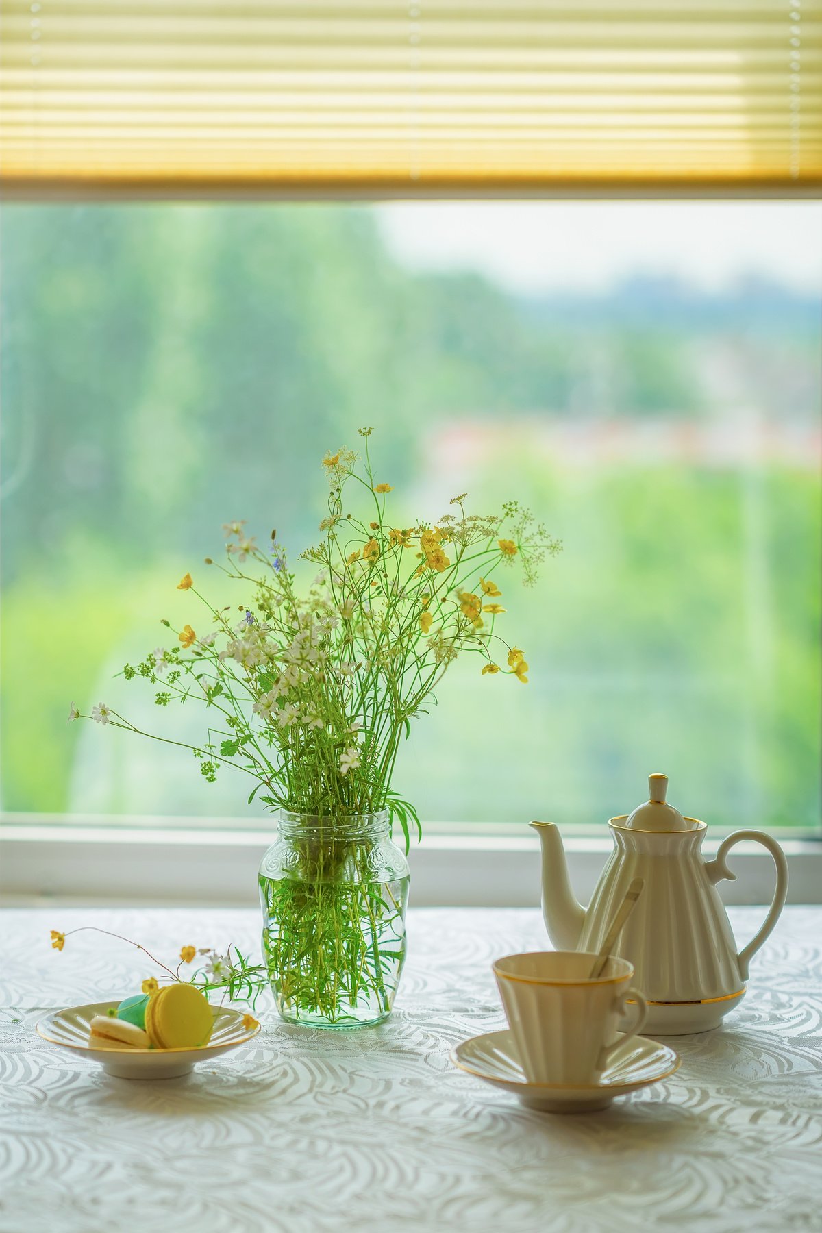 Bouquet of Flowers, Tea, Sweet Dessert on Table by the Window 